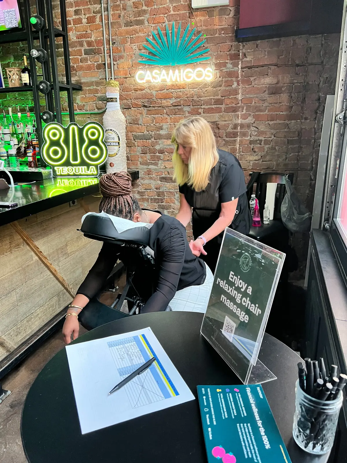 This is an example of a custom masseuse experience offered to guests at a happy hour.