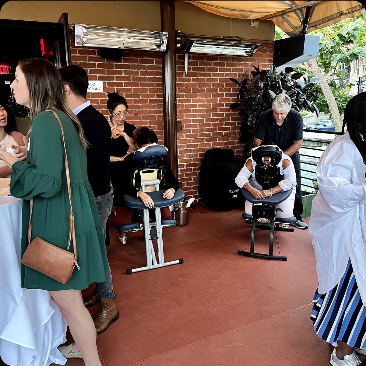 This is an example of a happy hour event with a massage experience hosted at a popular local restaurant and bar in San Francisco for a FinTech SaaS startup.